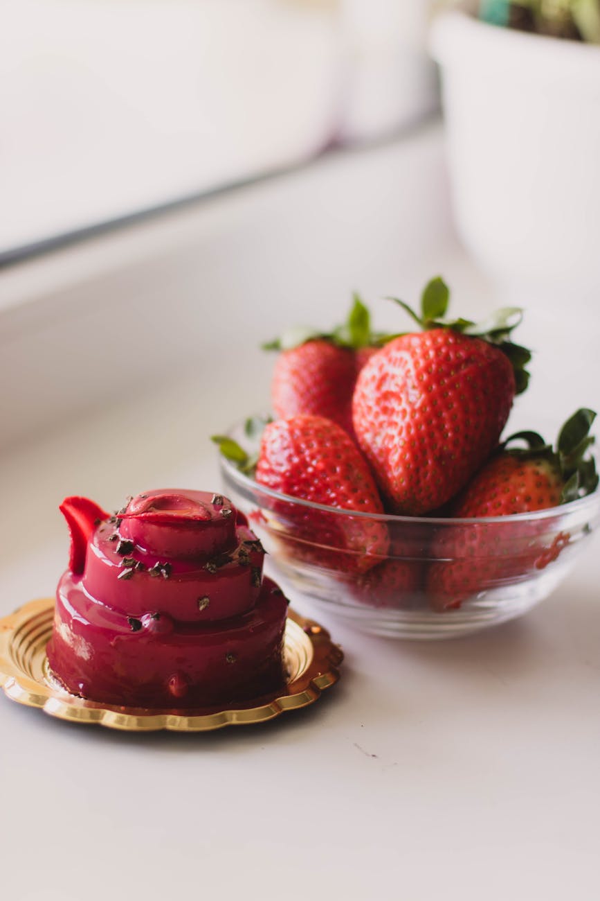 plate of cake and bowl of strawberries