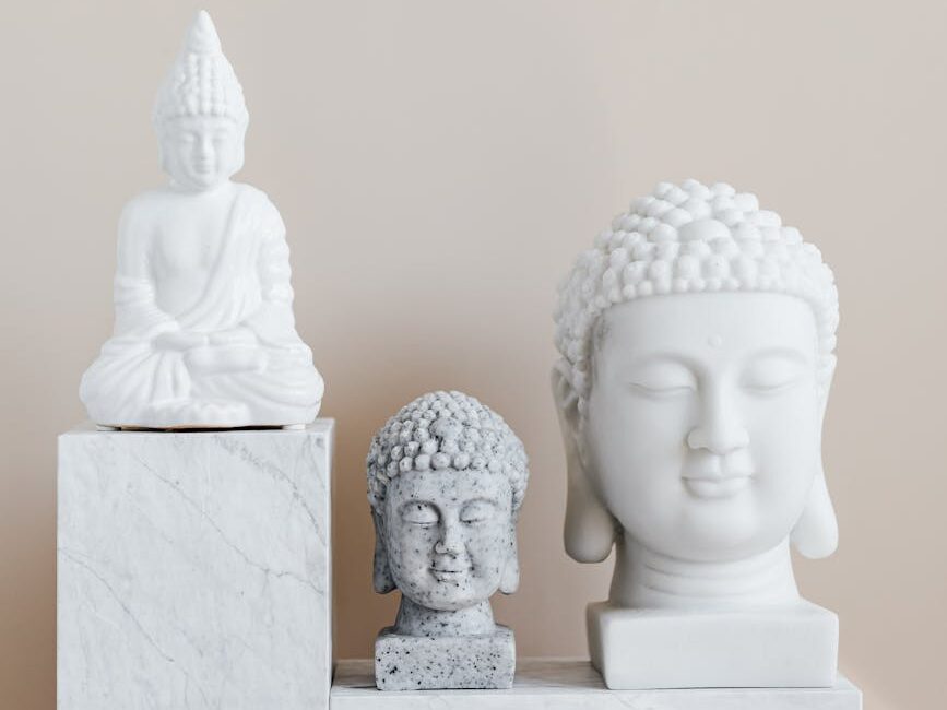 composition of buddha statues on marble stand
